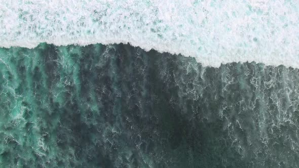Top View of Ocean Blue Waves Crashing Coastline Drone Footage