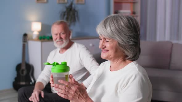 Retired Sports Beautiful Elderly Woman Athlete Replenishes Water Balance After Intense Training with