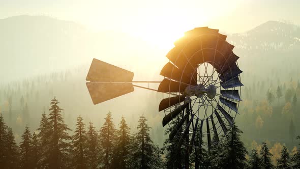 Typical Old Windmill Turbine in Forest at Sunset