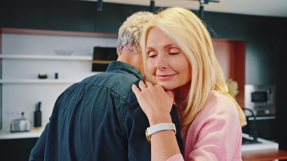 Close Up of Loving Aged Spouses Dancing at Kitchen Celebrate Anniversary of Strong Happy Marriage