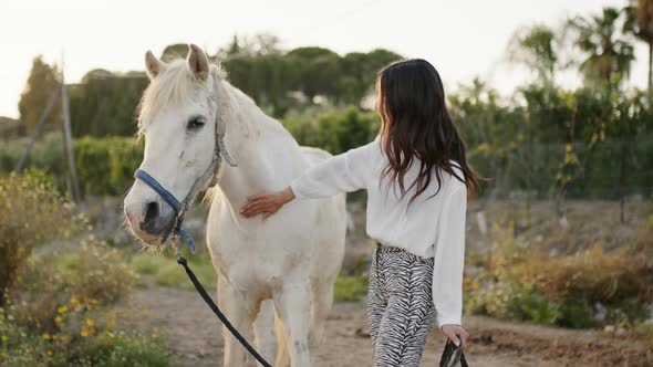 Girl Fond of White Horses in the Private Ranch