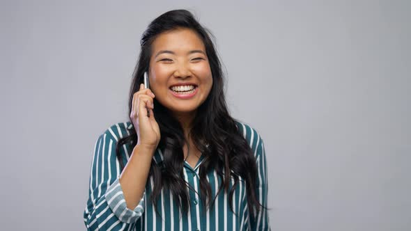 Happy Asian Woman Calling on Smartphone