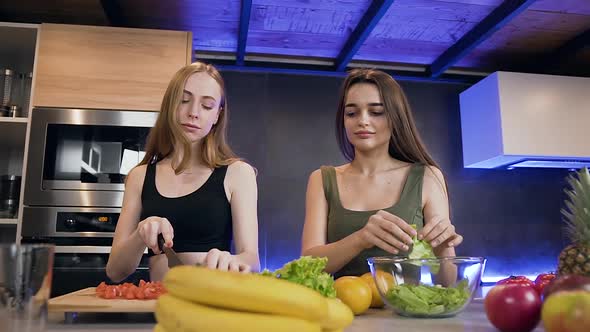 Women which Giving High Five, then Hugging Each other During Preparation Fresh Natural Salad