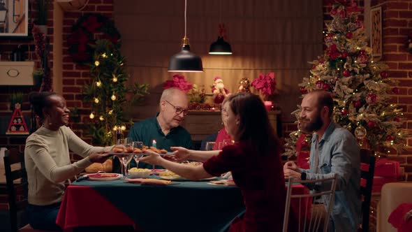 Positive Multicultural Family Members Celebrating Christmas with Special Evening Dinner