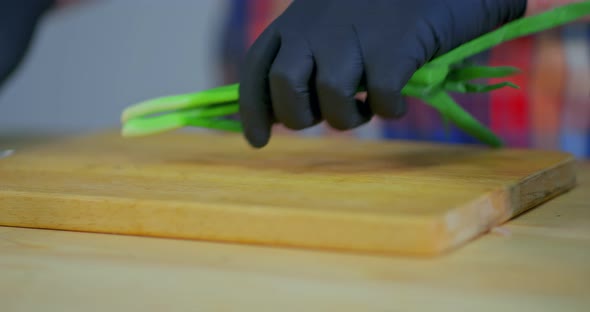 Green Onions are Cut Into Small Pieces with a Knife Closeup