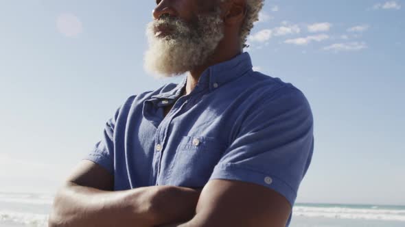 Senior african american man looking away on sunny beach