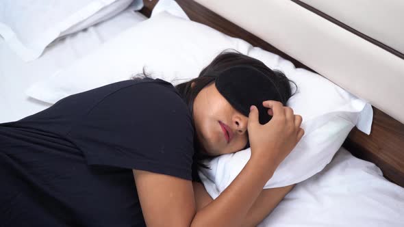 Indian woman sleeping with an eye mask on