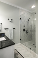 Modern bathroom with glass shower and marble tile. - PhotoDune Item for Sale