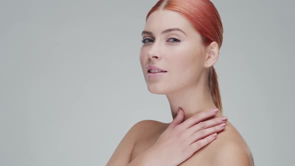 Studio portrait of young, beautiful and natural redhead woman. Beauty concept.