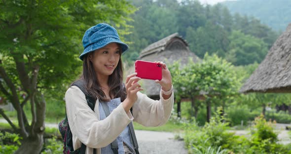 Woman take photo on cellphone in Japanese traditional house 