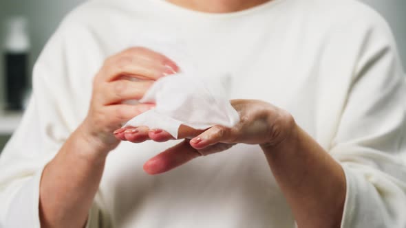 Old Woman Using Wet Wipes Closeup