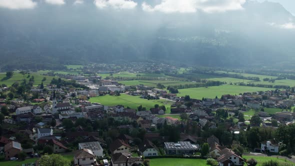 Aerial View of Liechtenstein with Houses on Green Fields in Alps Mountain Valley