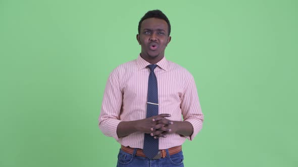 Stressed Young African Businessman Looking Around and Feeling Upset