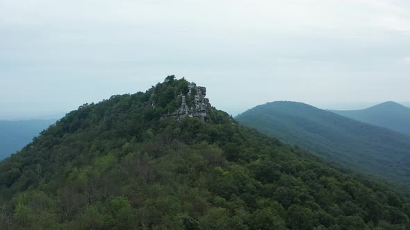 An aerial shot (dolly in, pedestal up) of Big Schloss and Great North Mountain in the evening in the