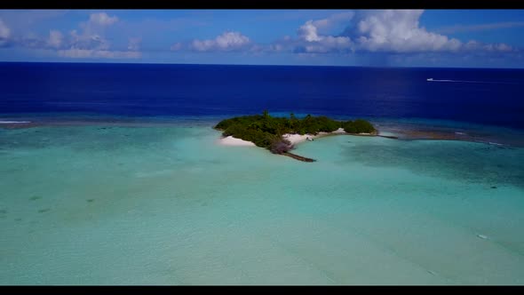 Aerial drone shot panorama of beautiful seashore beach vacation by aqua blue water and white sandy b