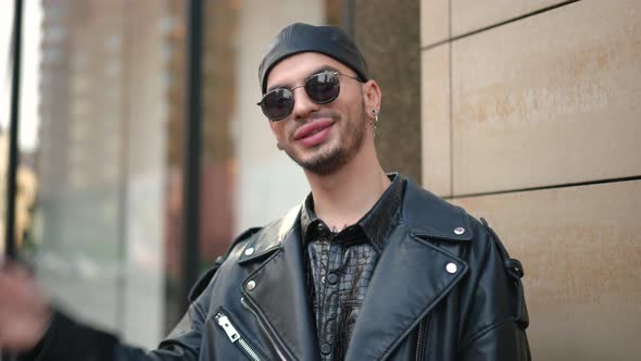 Confident Stylish LGBTQ Man in Sunglasses Gesturing Air Kiss Smiling Looking at Camera