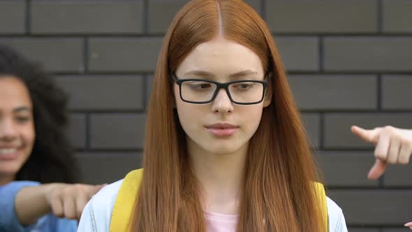 Mean Schoolchildren Pointing Fingers at Smart Girl, Teasing About Eyeglasses