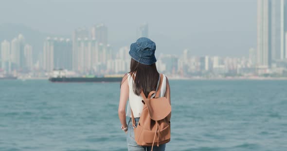 Woman look at the Victoria harbour in Hong Kong