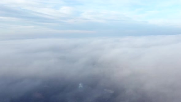 Aerial Drone View Flight Over Above Fog Mist and Roofs of Buildings in City