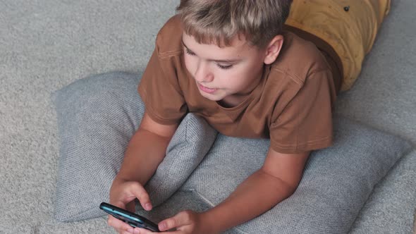 Pre Teenager Boy Browsing Content on Smartphone