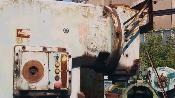 A Scrap Yard with Lathes in the Open Air is Rusting in the Open Waiting for Recycling