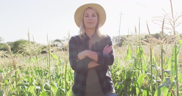 Video of happy caucasian woman standing in field on sunny day