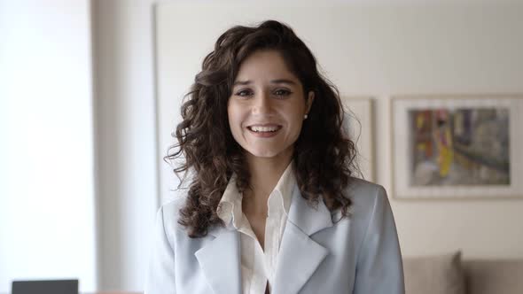 Front View of Smiling Business Expert Posing Indoors