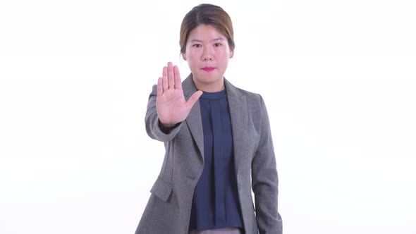 Serious Young Asian Businesswoman with Stop Gesture