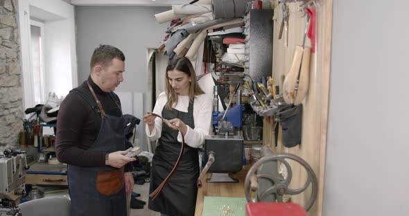 Craftsman and Woman Standing in a Workshop