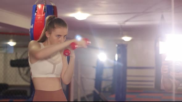 A Woman Boxer Trains Before a Fight a Girl Studies Combat Strikes