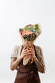 Woman's hands with tattoo hold floral bouquet of living coral color roses and green leaf on a - PhotoDune Item for Sale