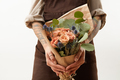 Close-up of greeting bouquet from fresh roses, eryngium and green leaves a in a female's hands - PhotoDune Item for Sale