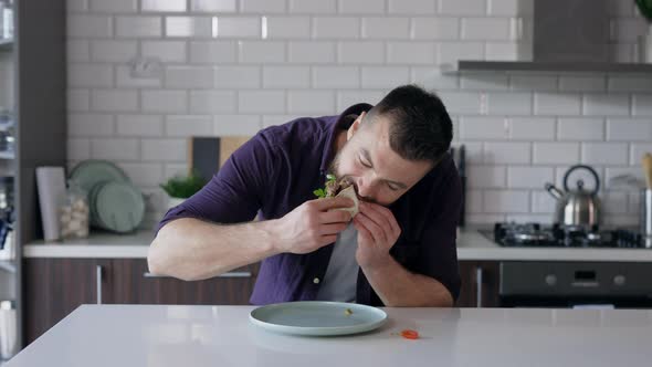 Man Eating Food in the Kitchen