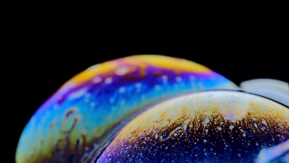 Macro Shot of a Soap Bubble Creates a Colorful and Black Background