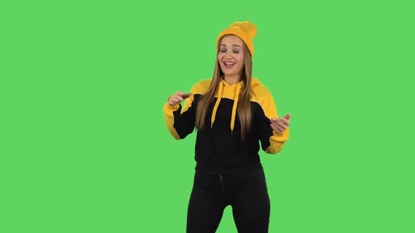 Modern Girl in Yellow Hat Is Clapping Her Hands with Dissatisfaction. Green Screen