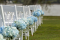 Bouquets of hydrangeas hanging from chairs for outdoor wedding. - PhotoDune Item for Sale