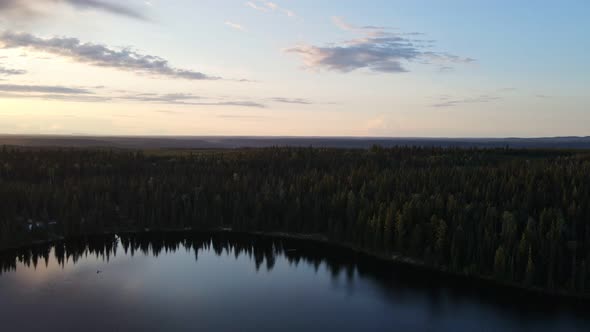 Dense, lush forest surrounding the stunning Cobb Lake in the countryside of British Columbia, Canada