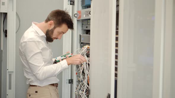 Network Engineer Working In Server Room.It Specialist On Computer Console In Server Room Data Center