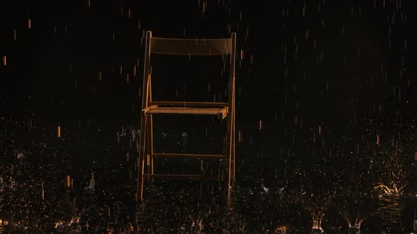 A Wooden Chair Stands in the Rain on the Water Surface in an Empty Dark Studio