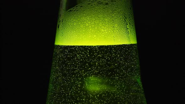 Green Bottle Neck With A Lot Of Bubbles Is On Black Background
