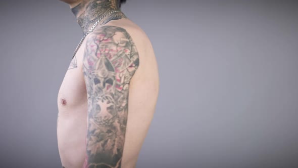 Unrecognizable Tattooed Man Turning Showing Tattoos on Hands Torso and Neck