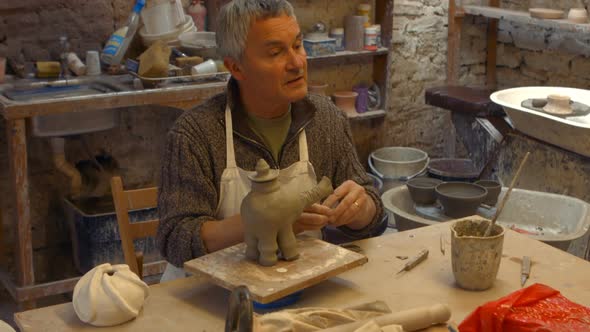 Potter working on clay sculpture