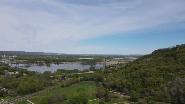 Drone view over wetlands in valley with bluff side and blue sky with wispy clouds. Wisconsin.