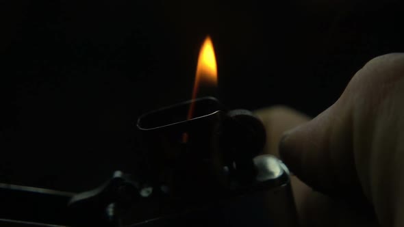 Striking A Lighter At Night