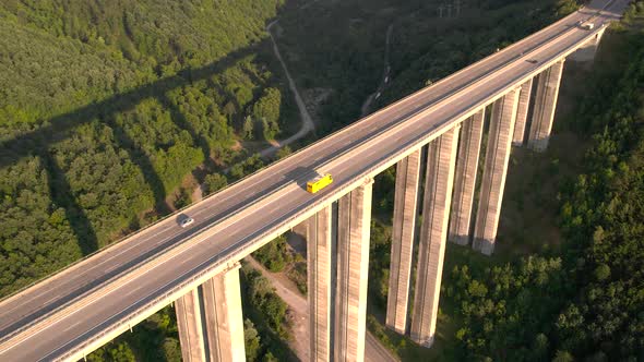 Aerial View of Yellow Truck or Bus Driving Slowly on Highway Viaduct Bridge