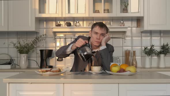 Exhausted Man Pouring Coffee Early in the Morning