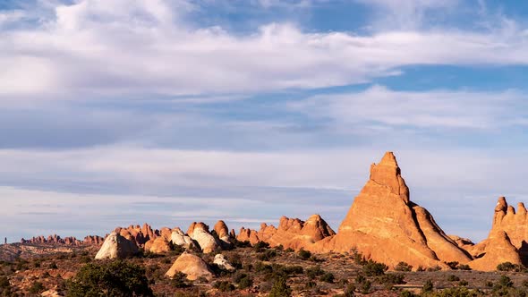 Timelapse looking past tall desert fins in Arches National Park