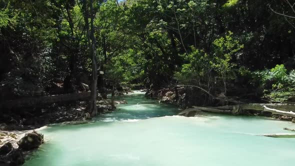 Drone shot over the river of the waterfall El Chiflon