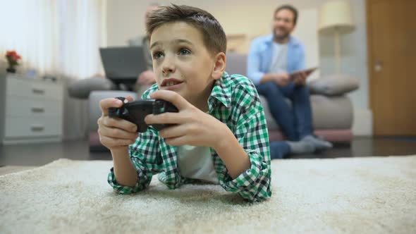 Preteen Boy Playing Video Game, Dad and Granddad Smiling, Leisure and Hobby