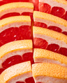 Fresh slices of ripe grapefruit presented in a row. Healthy Diet Fruit. Flat lay - PhotoDune Item for Sale
